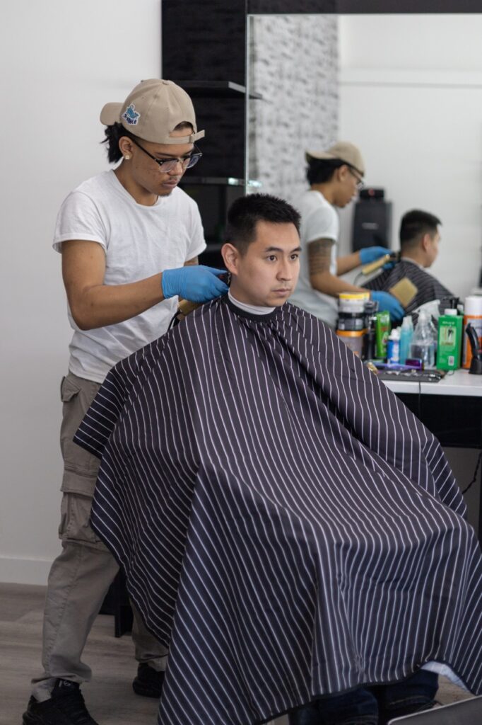 A snapshot from the photoshoot conducted by Sprobuj Digital Agency to commemorate the opening of FiveStar Barbershop's new location, capturing the excitement and energy of the event.